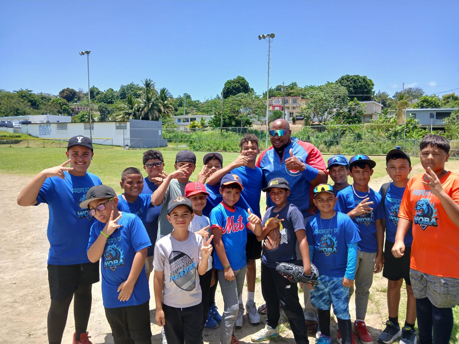 Wide group portrait of Coach K. Ross with the full team at a Puerto Rico clinic